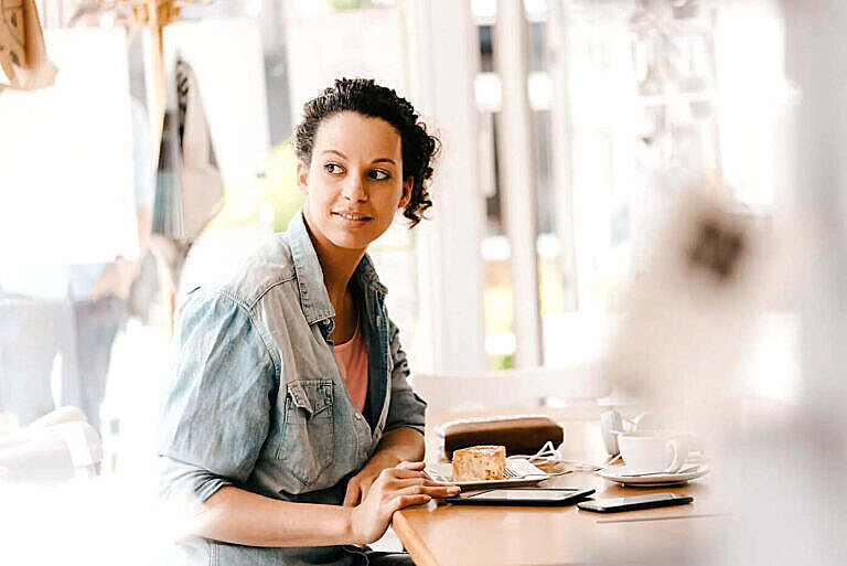 Young Woman Working in Coworking Space, Eating Cake